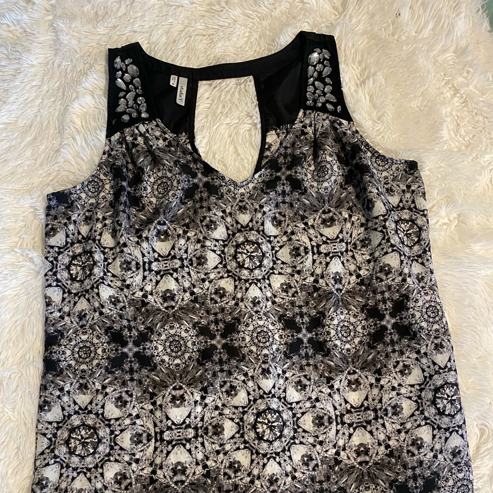 Sheer, sleeveless, rhinestone top. Medium